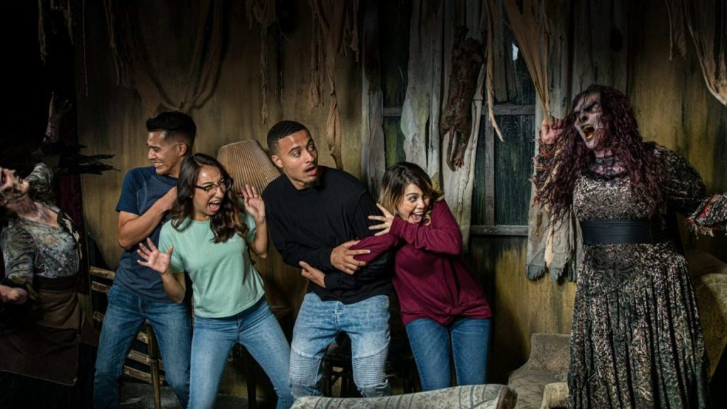 patrons being scared in a Fright Fest haunted house