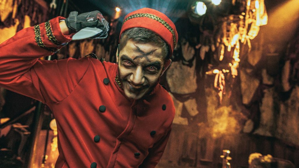 Haunt actor with prop knife from Cinema Slasher maze